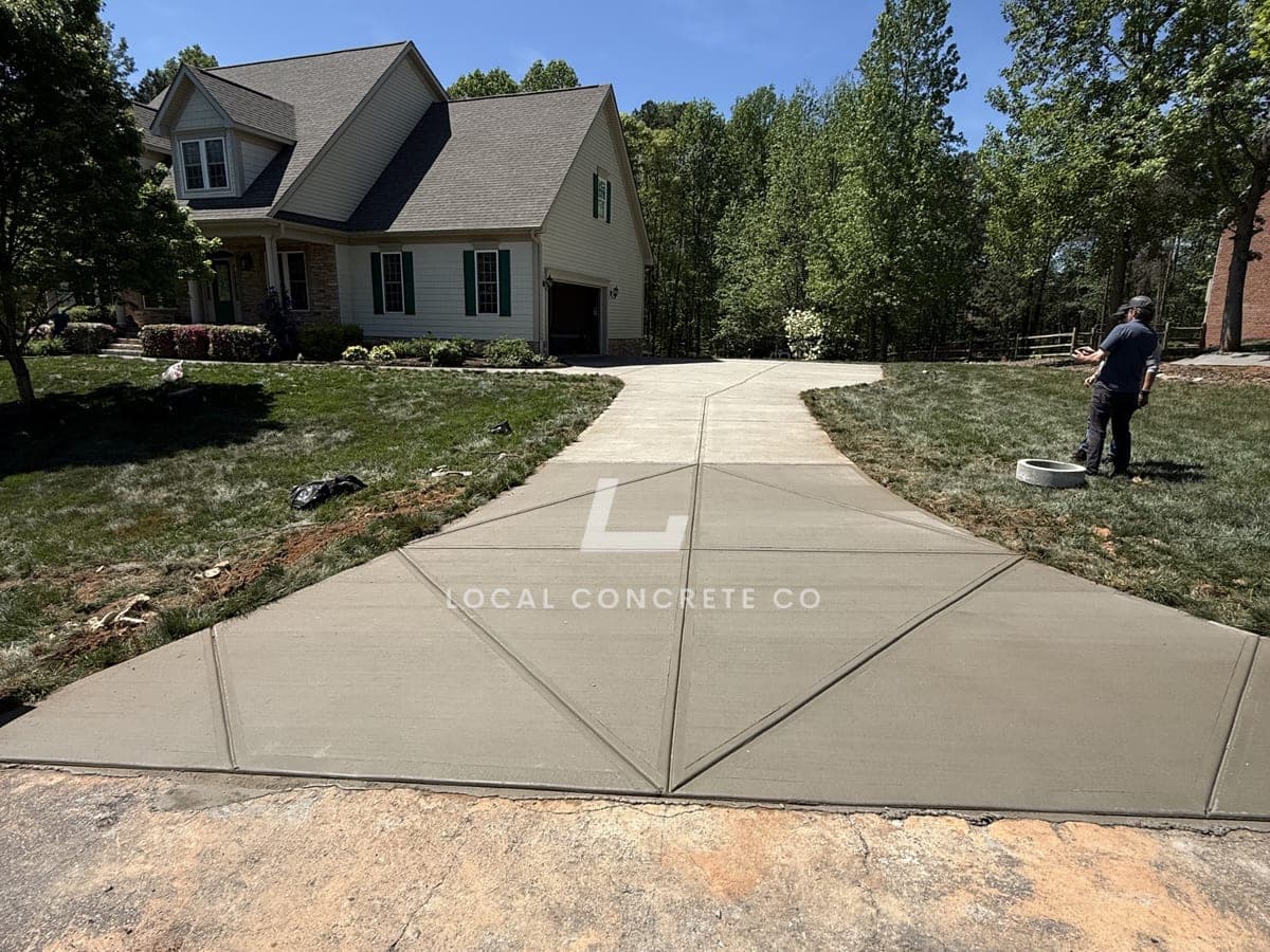 Newly poured Concrete Driveway Aprons in Charlotte, NC (Mecklenburg County) by Local Concrete Contractor — 4000 PSI mix, double-mat #4 rebar, broom-finish surface, 28-day full cure.