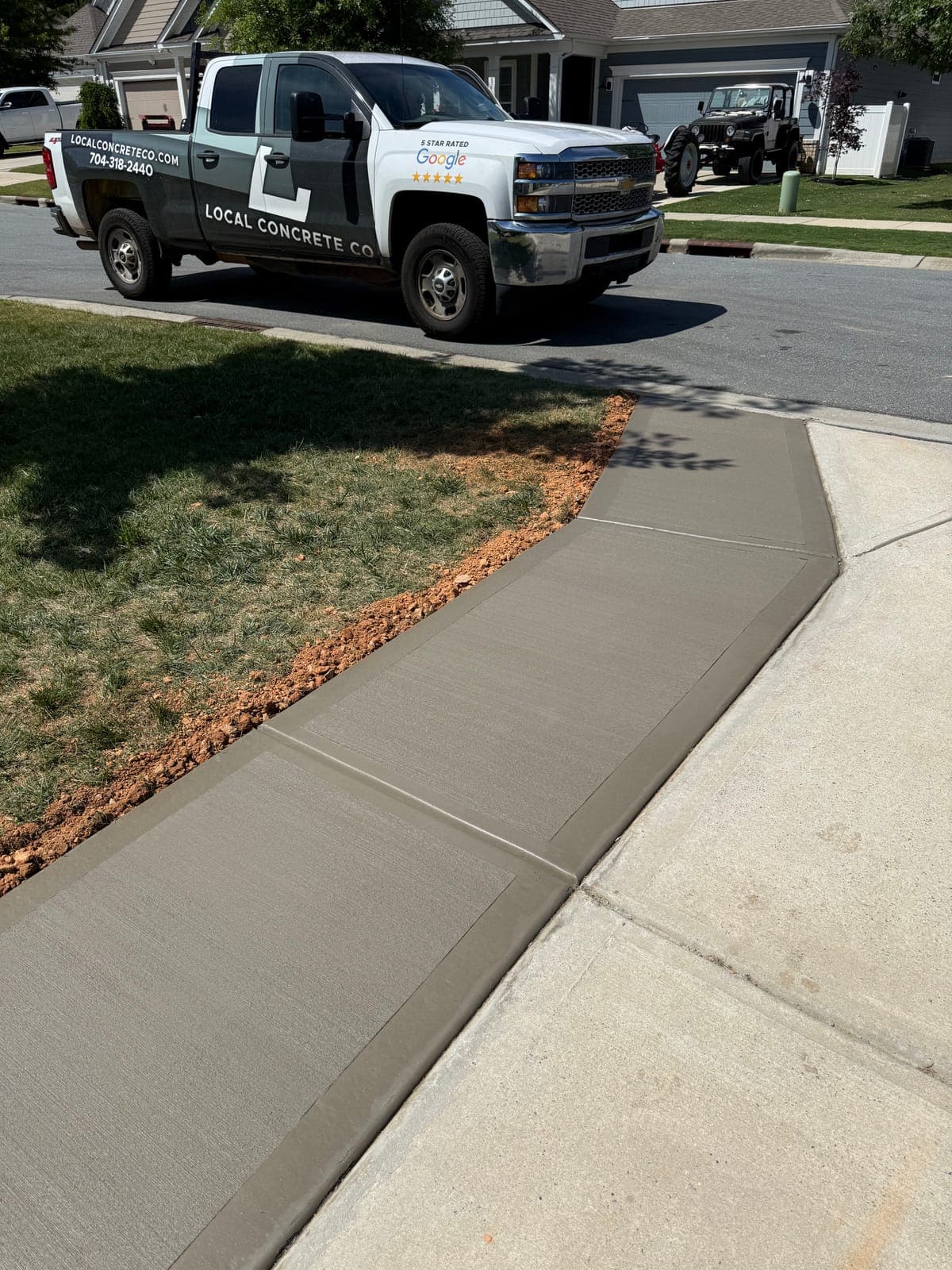 Concrete driveway extension in Charlotte, NC — poured tie-in to existing slab, matched finish by Local Concrete Contractor.