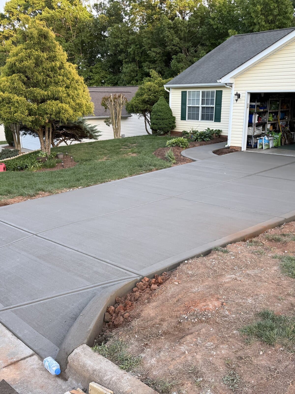 Concrete driveway installation in Charlotte, NC — poured slab, control joints, broom-finish surface by Local Concrete Contractor.