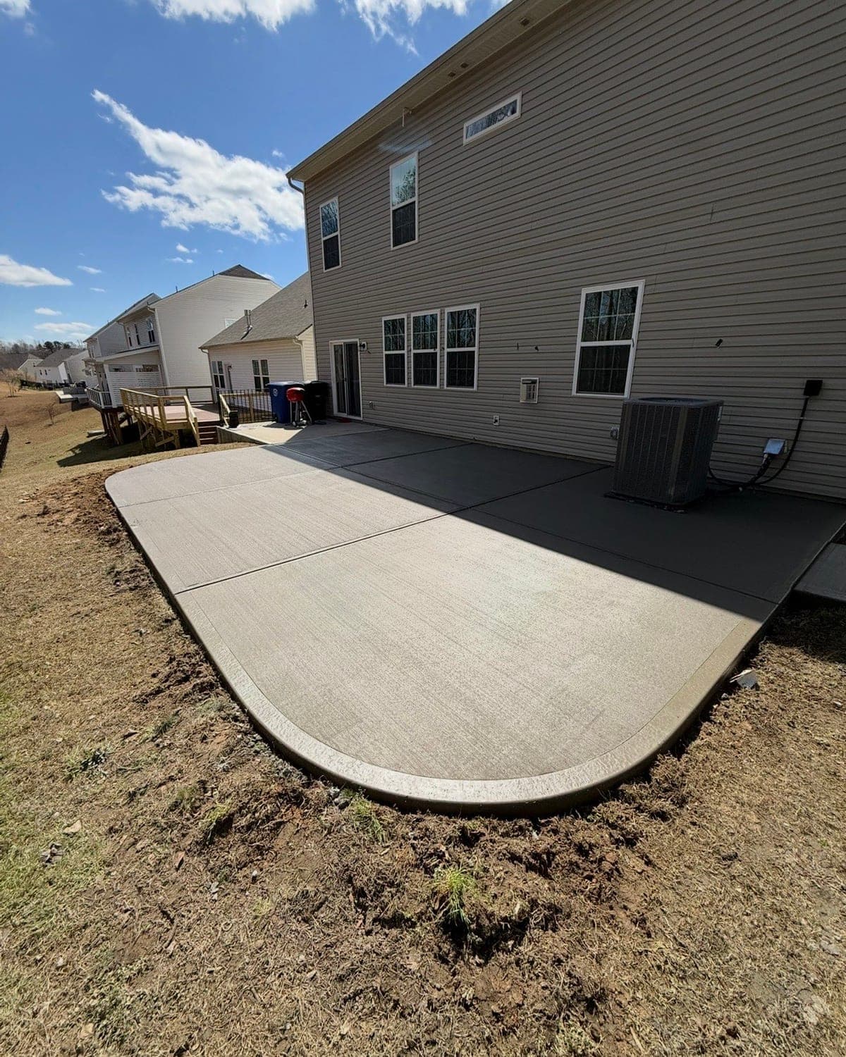 Newly poured Concrete Patios in Charlotte, NC (Mecklenburg County) by Local Concrete Contractor — 4000 PSI mix, double-mat #4 rebar, broom-finish surface, 28-day full cure.