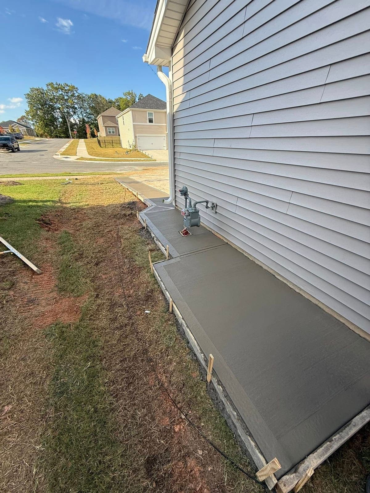 Finished Trash & Dumpster Pads job in Charlotte, North Carolina by Local Concrete Contractor — clean control-joint pattern, smooth troweled surface, full property protection during pour.