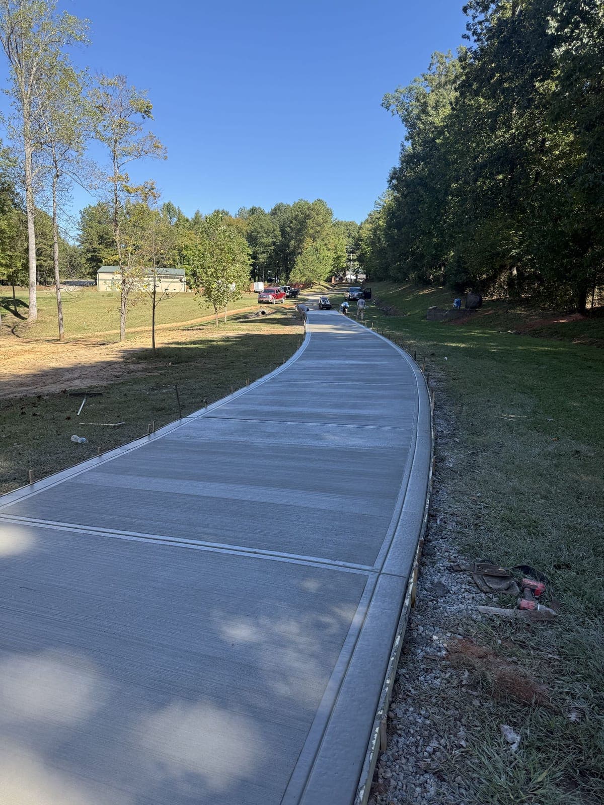 Newly poured Long Concrete Driveways in Charlotte, NC (Mecklenburg County) by Local Concrete Contractor — 4000 PSI mix, double-mat #4 rebar, broom-finish surface, 28-day full cure.