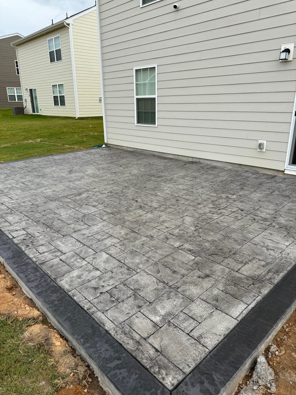 Stamped concrete repair in Charlotte, NC — pattern-match patch, color re-tint, resealing by Local Concrete Contractor.