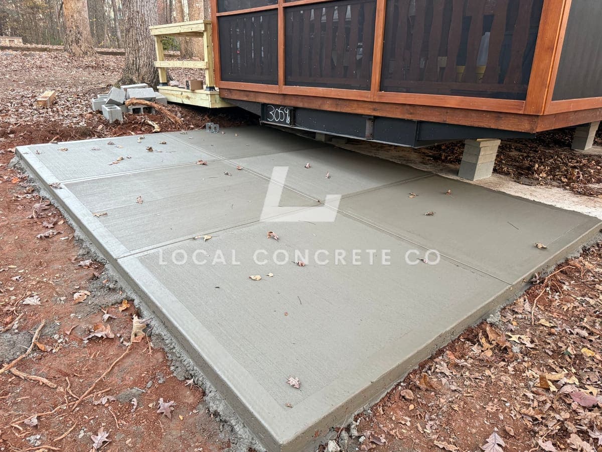 Finished Concrete Patios job in Fuquay-Varina, North Carolina by Local Concrete Contractor — clean control-joint pattern, smooth troweled surface, full property protection during pour.