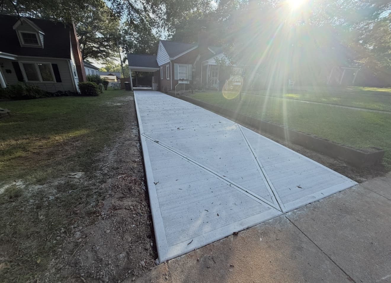 Concrete driveway installation in Indian Trail, NC — poured slab, control joints, broom-finish surface by Local Concrete Contractor.